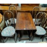 Oval oak drop leaf dining table on turned legs and a set of 4 Windsor style dining chairs
