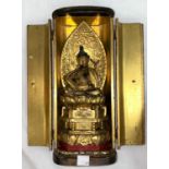 A Japanese wooden cased portable shrine with double doors and figure on pillar inside, height 27cm