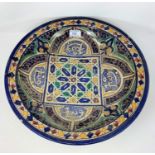 A middle eastern earthenware charger with geometric designs, signature to base, diameter 38.5cm