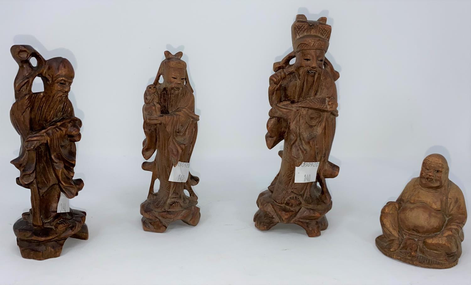 Three 20th century carved wood figures of Immortals heights 14-16 cm and a similar Buddha figure