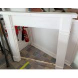 A painted wooden fireplace surround