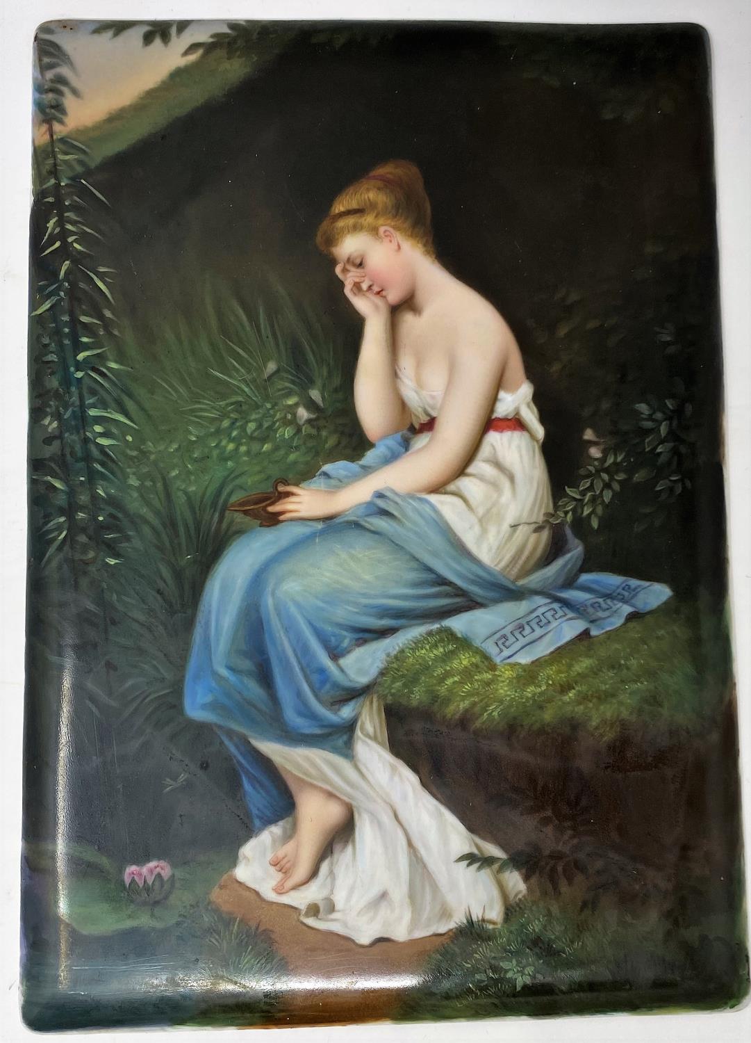 A 19th century ceramic rectangular plaque depicting a young woman seated by a woodland pond,