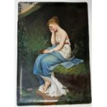 A 19th century ceramic rectangular plaque depicting a young woman seated by a woodland pond,