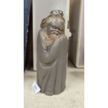 A Lladro Society bisque figure: oriental monk, height 21 cm