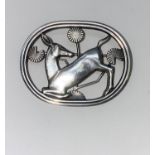 A Georg Jensen Danish silver oval brooch depicting kneeling deer, stamped GJ in rectangle, 925S,