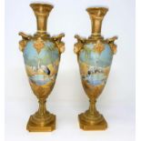 A pair of Royal Worcester balluster vases with ornate gilt neck, facemask mounts decorated with