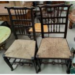 A near matching pair of 19th century Lancashire spindle back chairs with rush seats and turned legs