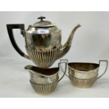A hallmarked silver 3 piece pedestal coffee set in the Georgian style with reeded lower sections,
