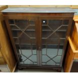 A Georgian style mahogany display cabinet enclosed by 2 astragal glazed doors