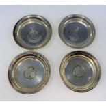 A set of 4 Iranian small white metal dishes with inset coins, stamped '800'