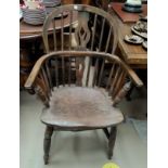 A 19th century elm Windsor armchair with low back and pierced splat, on turned legs