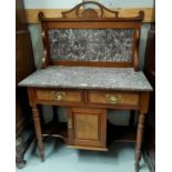 An Edwardian walnut washstand with marble top