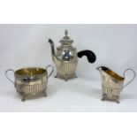 A Georgian style 3 piece Swedish chocolate set with reeded lower bodies and paw feet with