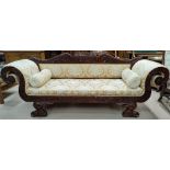 A reproduction William IV style mahogany scroll arm settee/chaise longue with detailed carved