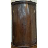 An 18th century oak panelled bow front corner cupboard height 113cm