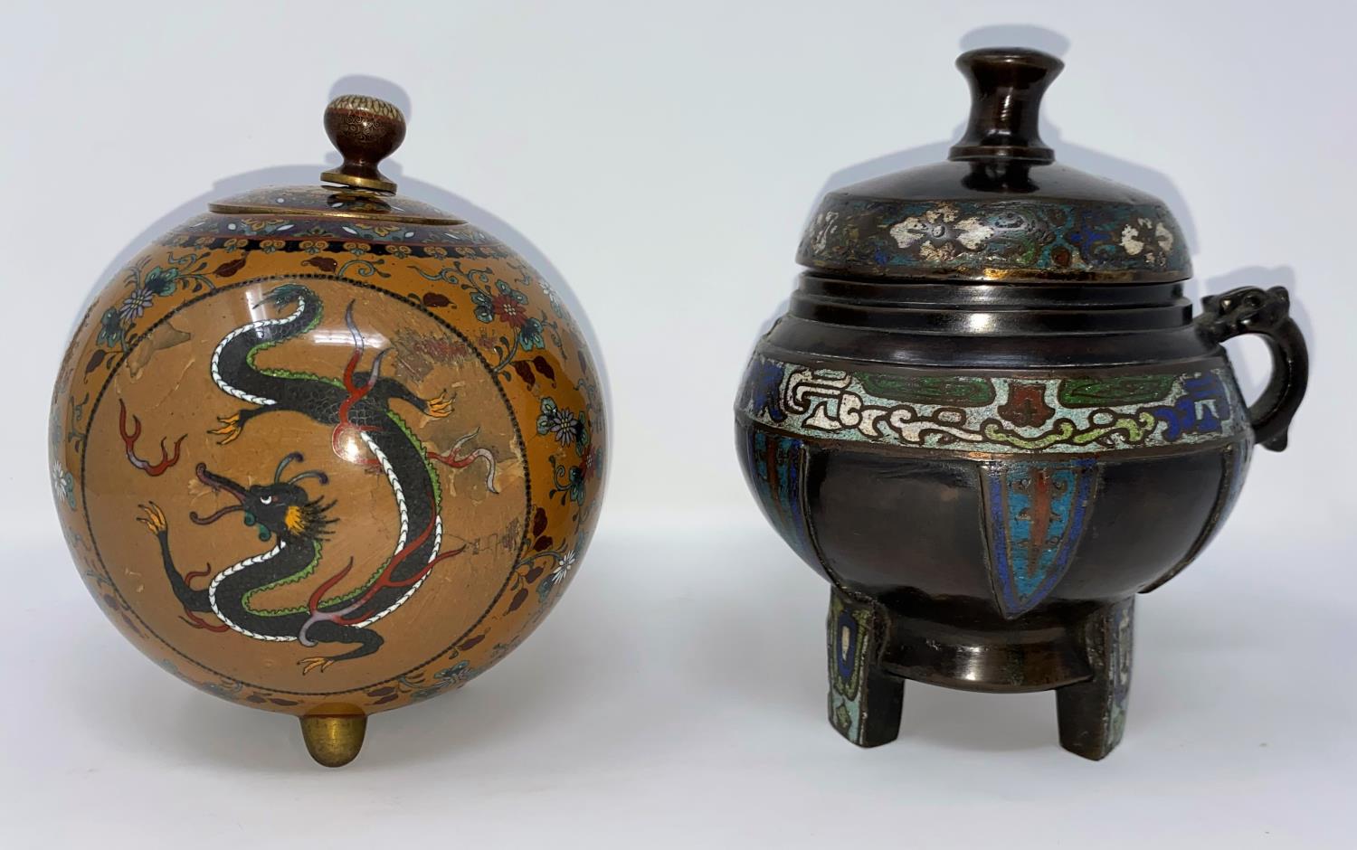 A Japanese cloisonné covered vase of ovoid form, finely detailed with reserve panels of exotic Ho-ho