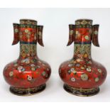 A late 19th/early 20th century Japanese pair of cloisonné vases of compressed onion form with tall