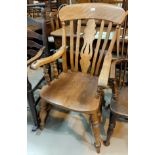 A 19th century stripped beech farmhouse armchair with fiddle back