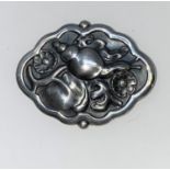A Georg Jensen Danish silver shaped oval brooch depicting a snail and flowers in relief, stamped
