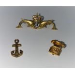 A Submariner's lapel badge in 9 carat hallmarked gold and enamel; a 9 carat hallmarked telephone