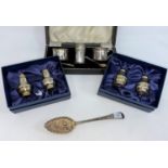 A 3 piece cruet, cased, Birmingham 1938; 2 salt and pepper pots, boxed, Birmingham 1973; a pierced