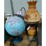 A modern terrestrial globe; a peach lamp