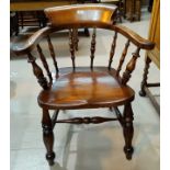 An early 20th century smokers bow armchair