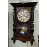 A small A Victorian style pine Vienna style wall clock in mahogany case, with striking movement