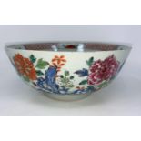 An 18th century Chinese punch bowl with polychrome decoration of flowers, diameter 24cm (minor