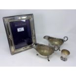 A hallmarked silver photo frame, Sheffield 1991; 2 silver plated sauce boats, egg cup etc