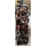 A large Chinese carved wooden figure of a sage walking with a small animal. height 90cm