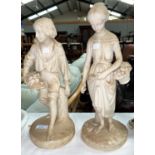 A 19th century pair of Copeland parian figures of a boy and girl carrying baskets of fruit,