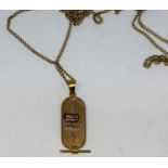 A Middle Eastern pendant with raised Egyptian hieroglyph, unmarked, tests as circa 18 ct