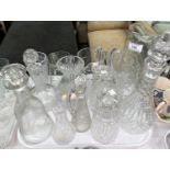A modern 2 bottle tantalus; a selection of cut glass decanters; jugs; etc.