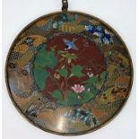 A late 19th/early 20th century Japanese cloisonné circular wall plaque, the central panel with