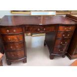 A mahogany reproduction twin pedestal desk with inset top and 9 drawers