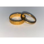 A 22 carat hallmarked gold wedding ring with chequered line decoration, 4.3 gm; a 9 carat hallmarked