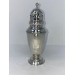 A silver sugar dredger of ribbed tapering form with pierced domed top and circular foot, B1932 3.5oz