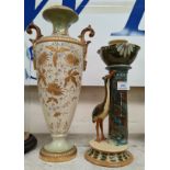A Torquay pottery majolica candlestick with heron; an ivory and gilt baluster vase