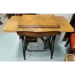 A cast iron base and oak table for a Jones treadle sewing machine (no machine)