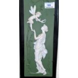 A bisque wall plaque depicting a woman and fairy in white relief against a green ground, height 32.