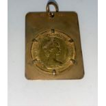 A QEII sovereign, 1974 in 9 carat hallmarked gold rectangular mount, 13 gm gross