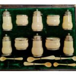 An originally cased 10 piece cruet set in hallmarked silver mounted ivory, Birmingham 1902