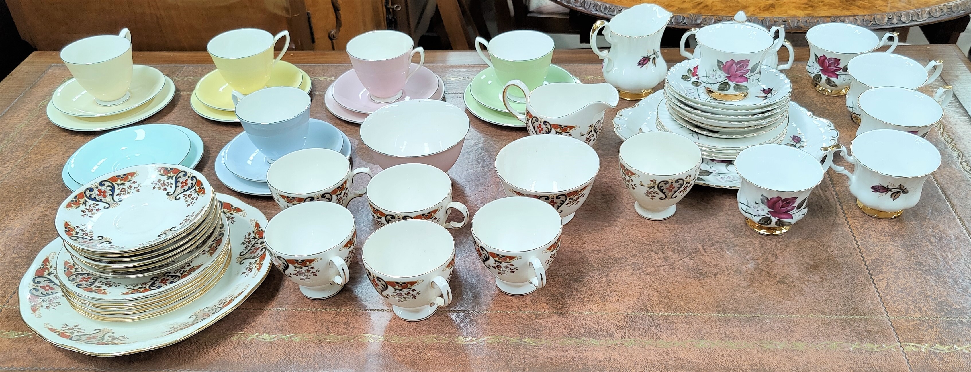 A Royal Albert part Harlequin tea service, a Colclough part tea service and another