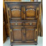 An oak Titchmarsh and Goodwin oak side cabinet with double cupboard above and bellow two drawers and