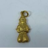 A yellow metal Buddha pendant stamped 18K, 2.4gm