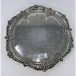 A Victorian hallmarked silver circular scalloped salver with headed accanthus border with 3 ball and