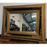 A large rectangular wall mirror in 19th Century style, wide ornate gilt frame, overall 145 cm x