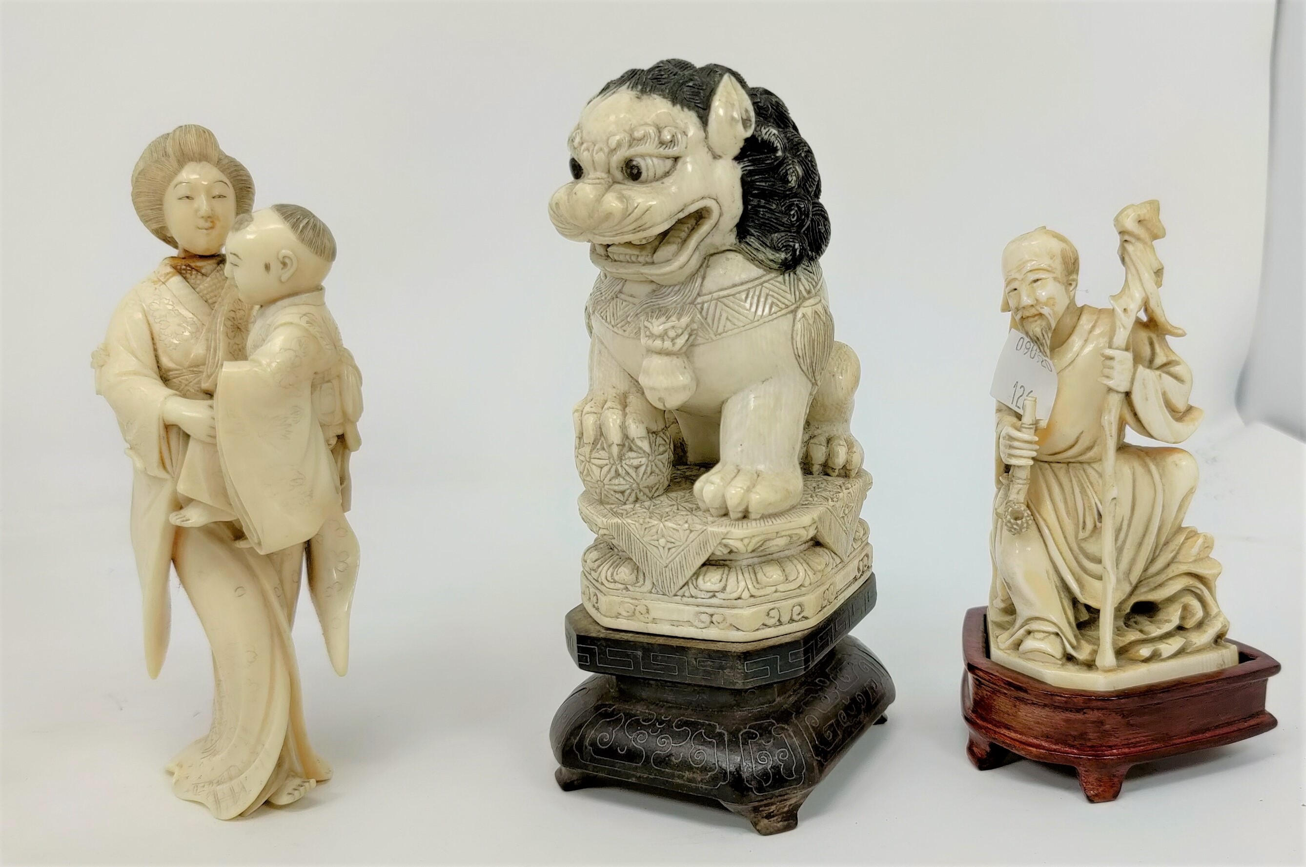 Three late 19th / early 20th century carved ivory Japanese figures, woman with baby,