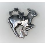 Georg Jensen: a silver brooch designed by Arno Malinowski, gambolling lamb with ivy overlay, stamped